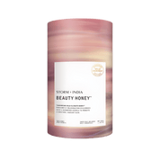 A cylindrical container with pink and beige swirls, labeled JING Organics Storm + India Beauty Honey, sits upright. The label notes Tasmanian cold climate honey, contains 30 sachets, and displays a gold Wild Harvest stamp.