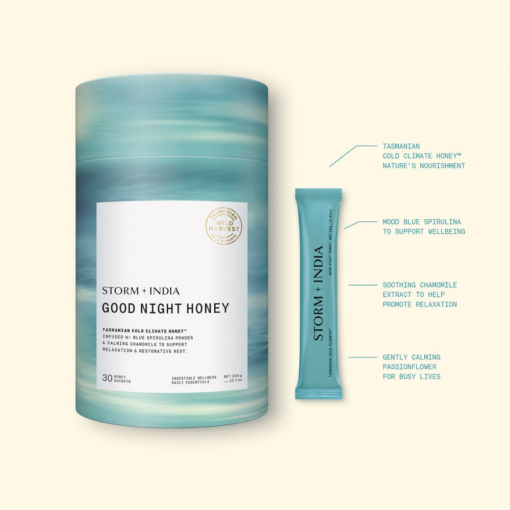 A cylindrical container and single-serve stick pack of JING Organics Storm + India Good Night Honey, featuring blue-green packaging with highlighted Tasmanian honey and blue spirulina ingredients for relaxation and wellbeing.